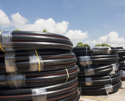 Variety of poly pipe in yard.